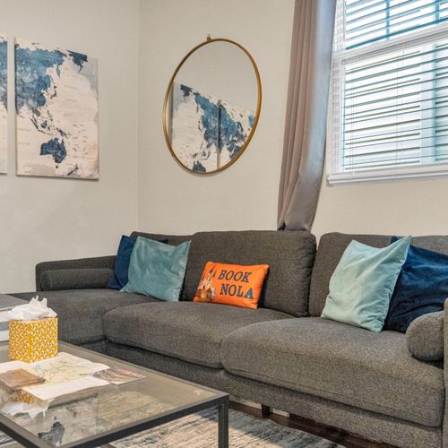 Comfortable living room sofa w/ teal throw pillows — perfect for lounging.