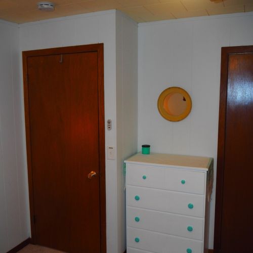 Bedroom #2:  features a full-size bed, bunk bed (i. E. 2 single beds on top of each other), ceiling fan, dresser, mirror, and closet.