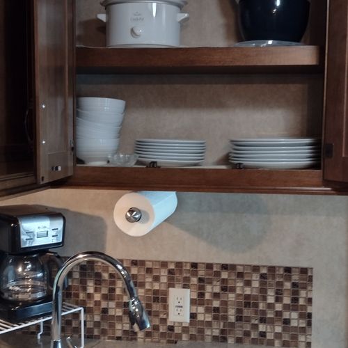 Kitchen:  the home has a cute little kitchen with a refrigerator, sink, counter, stove, oven, and microwave. There is also a collection of cooking and dining utensils provided.