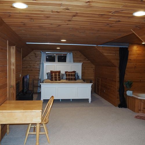 Bedroom #2 (second floor):  this is a huge upstairs bedroom with it's own television, desk, jetted tub, king-size bed, dresser, mirror, closet, and private en suite bathroom!