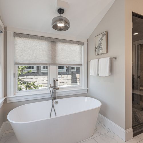 Chic, modern bathroom with steam shower and soaker tub