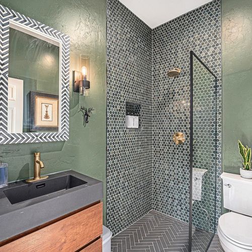 Freshen up in this stylish powder bath, complete with a sleek walk-in shower for ultimate convenience.