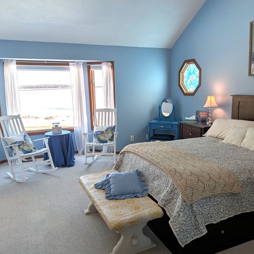 BEDROOM #2 (SECOND FLOOR):  The home has a huge primary bedroom on the second floor with a queen-size bed, private ensuite bathroom, and great views of Big Platte Lake!