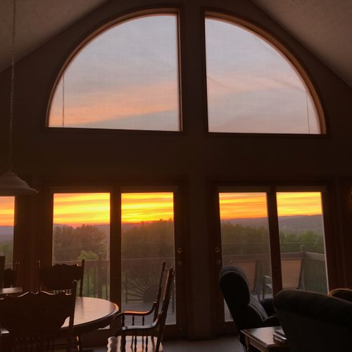 Overall:  the living room and deck with the sunset in the background