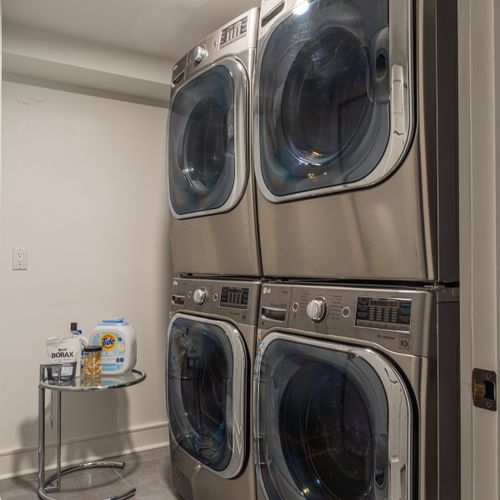 Additionally, you'll find dual washing machines and dryers on the bottom floor, just across from the lounge area.