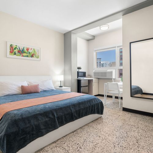 Discover a warm and welcoming atmosphere in this charming bedroom, perfect for unwinding and feeling right at home during your visit.