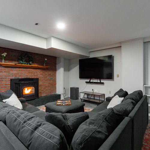 basement with pellet stove and unbelievably comfy couch!