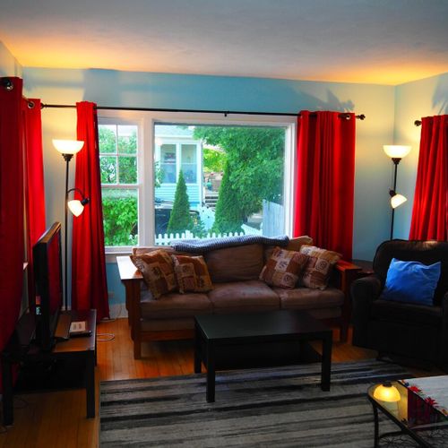 Living room:  comfy and cozy living room with sofa, comfy chair, futon, 2 coffee tables, and a large live streaming television that uses the cottage's high-speed cable wi-fi.