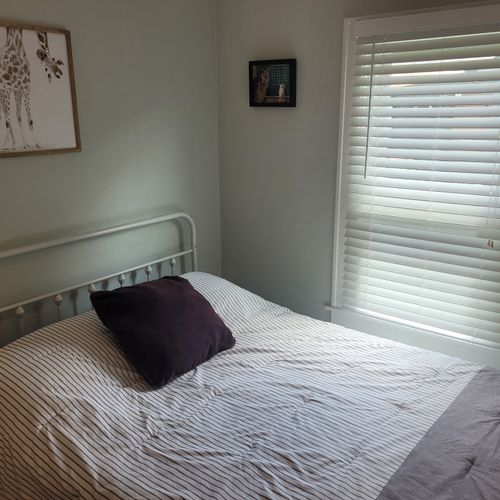 BEDROOM #2:  Features a full-size bed, dresser, lamp, mirror, and closet.