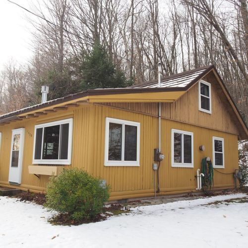 Exterior:  the outside of the cabin in the winter.