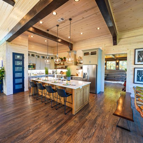 Come together in the open living/kitchen/dining space where gourmet style meets rustic warmth—every moment feels effortless here.