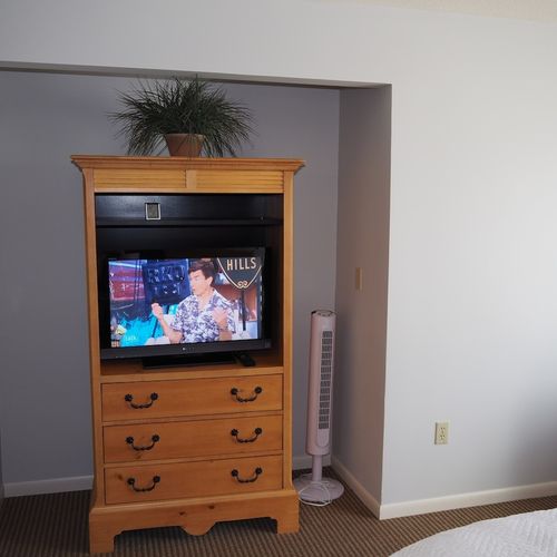 Master bedroom:  features a king-size bed, comfy chair, private balcony, nightstands with lamps, closet, its own television, and a private full en-suite bathroom!