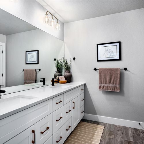- freshen up in this stylish bathroom featuring a spacious vanity and sleek black fixtures