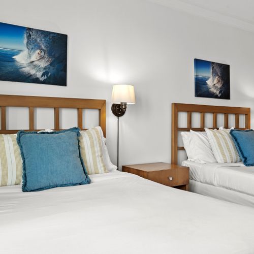 Comfortable and stylish studio with two inviting beds, offering a restful night's sleep.