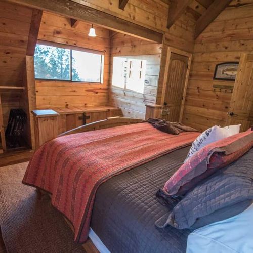 This bedroom comes with bright windows into the outdoors.