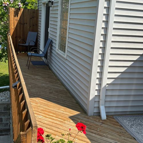 EXTERIOR:  The other end of the backyard deck.  The entrance to the deck from the master bedroom is where the chairs are at.