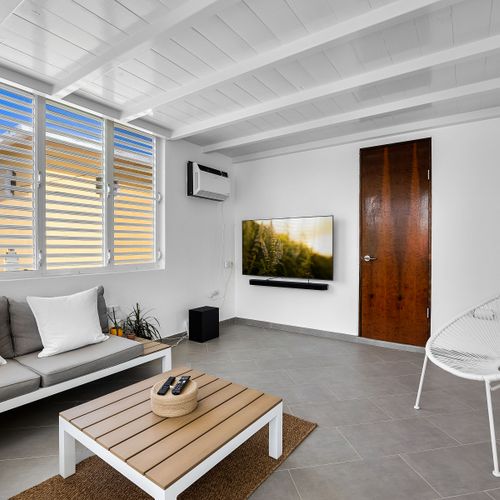 Kick back in the sun-filled lounge, featuring a soft sofa and large window – a perfect space to unwind, read a book, or binge your favorite series in comfort.