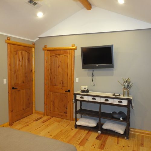 Bedroom #3:  this bedroom has both a closet as well as the shelving unit that is shown in the photo. It also has its own television. The door on the right is to the closet and the door on the left goes to private en suite bathroom.