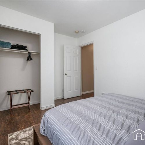 - clean and simple bedroom features smooth wood flooring and built in closet space
- neutral bedding and bright walls create a fresh and uncluttered atmosphere
- ideal for relaxing naps or uninterrupted night time sleep