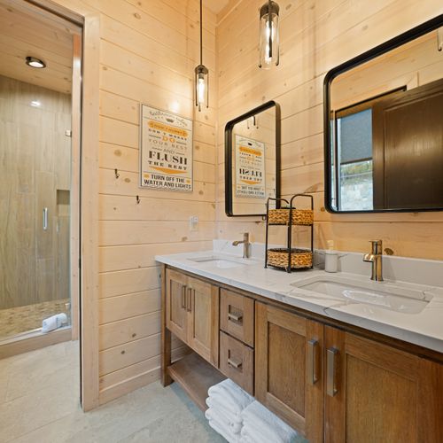 Complete with a stunning tile shower and crisp, luxurious finishes, this ensuite bathroom is a calming retreat where clean lines meet rustic elegance!
