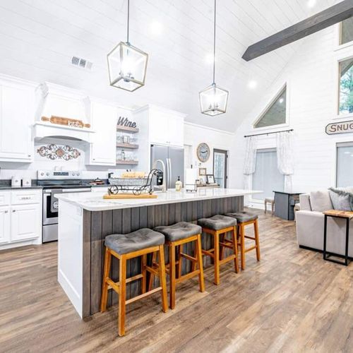 The kitchen with 4 stools at the island.