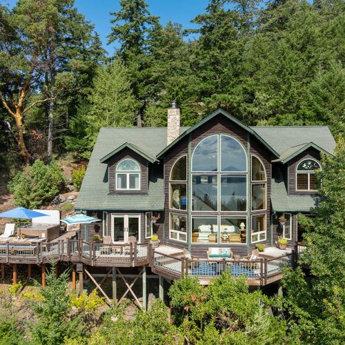 Decks and gardens surround the entire home