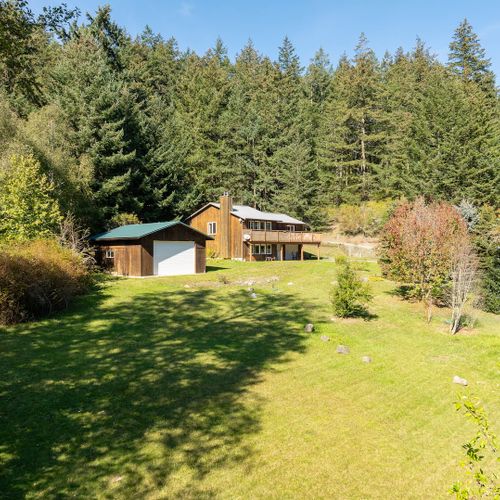 Expansive lawns and flowers beds make this a unique island home.