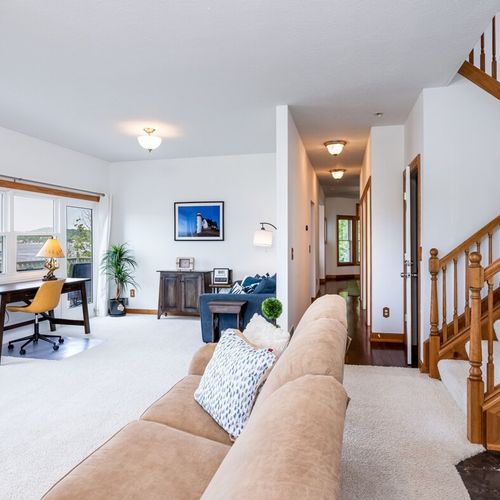 Living room:  the home has a large and lovely living room with comfy furniture, a gas fireplace, a desk, a large television with free living streaming, and great views of betsie lake!