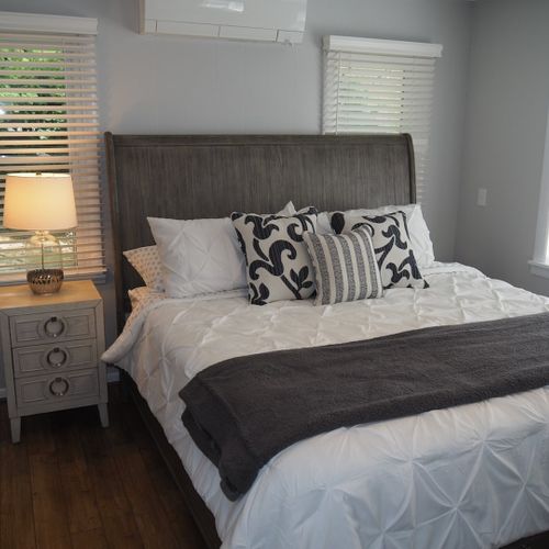 Bedroom #2 (first floor):  gorgeous master bedroom with queen-size bed, lakeview, walk-in closet, dresser, mirror, private a/c unit, ceiling fan, and private en suite bathroom. Located on first floor just off of the second living room.