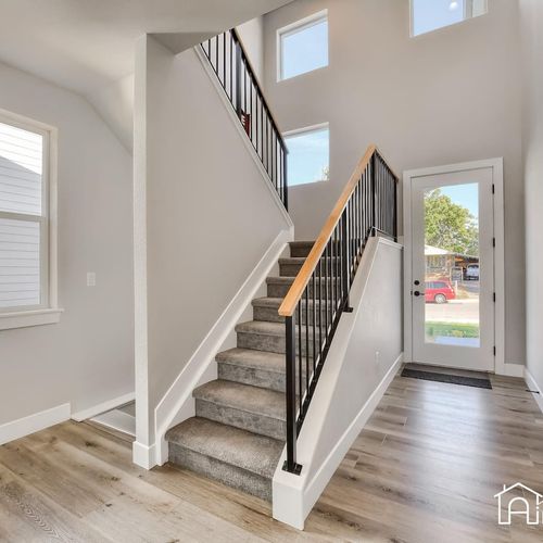This home boasts a central staircase, lofty ceilings and airy windows, letting in lots of natural light.