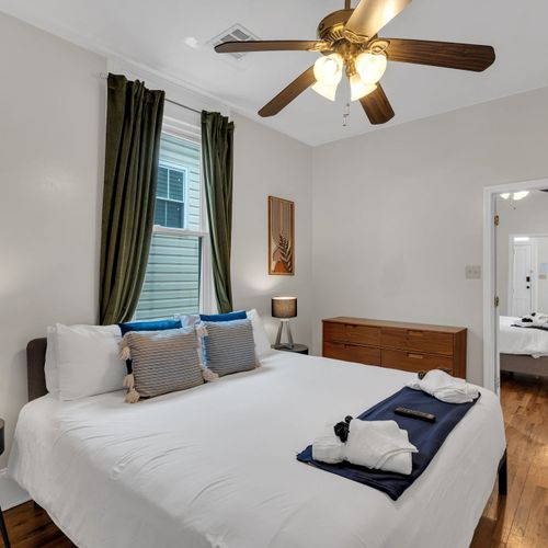 Comfortable bedroom w/ warm wood tones & soft natural light.