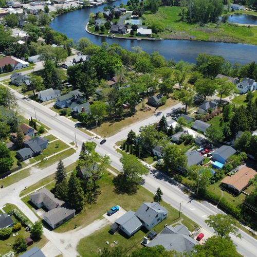 Exterior:  an aerial photo with the house in the foreground and the au sable river in the background.