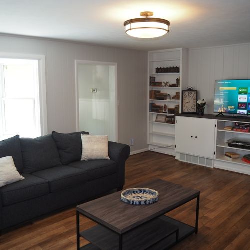 Living room #2:  very cozy with sofa, fireplace, comfy chairs, and live streaming television.