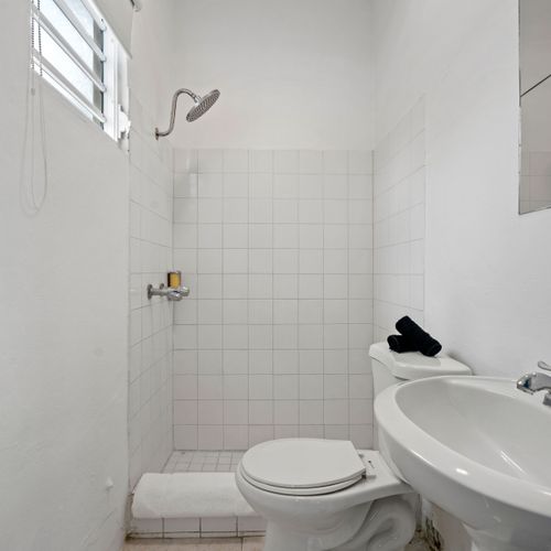 Bright and pristine, our bathroom vanity provides ample space for your personal items. The well-lit mirror ensures you can get ready with ease, adding to your comfort and convenience.