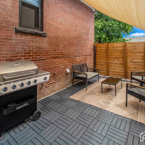 Our cozy fenced backyard with a charming patio is your private oasis