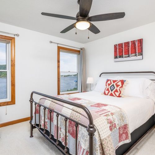 Bedroom #2 (second floor):  features a queen-size bed, ceiling fan, closet, and great views of betsie lake!