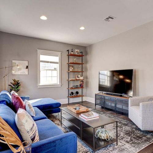 Comfortable living room w/ TV — settle in for a laid-back movie night.