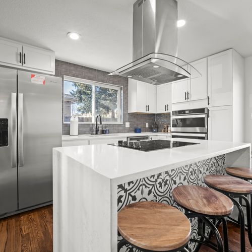 Kitchen island with stone countertop and seated bar