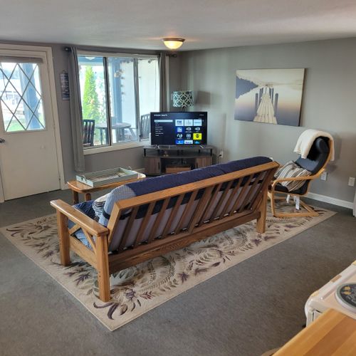 Living room:  cozy living room with a futon, chair, streaming television, and a great view of van etten lake!