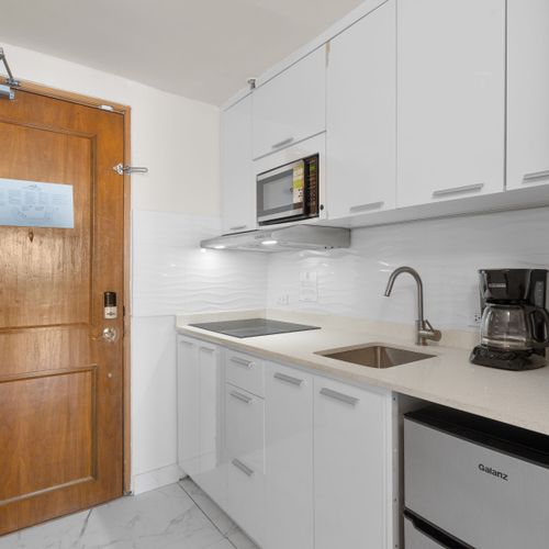 Sleek and fully equipped kitchenette ready for your culinary adventures. Cook with ease and style!