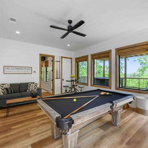 The game room featuring a pool table and patio access!