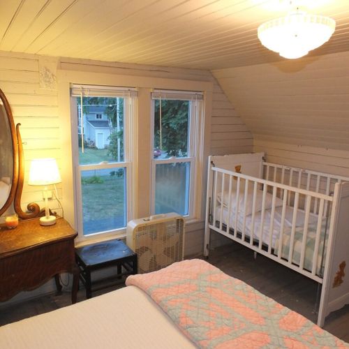 Bedroom #3 (second floor):  features a full-size bed, baby crib, dresser, mirror, and closet.