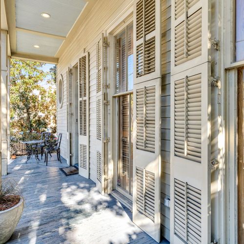 Relax on the shaded porch with classic French doors.