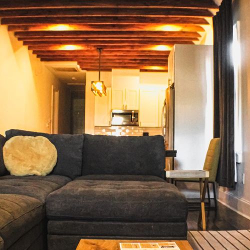 Exposed beams & a deep sectional — where NOLA charm meets modern comfort.