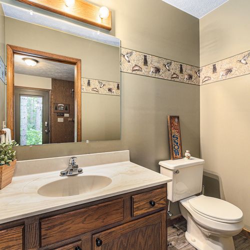 HALF-BATH (MAIN FLOOR):  There's a convenient half-bath located near the main entrance.