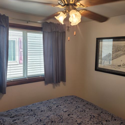 Bedroom #2:  features a full-size bed, ceiling fan, dresser, and closet.