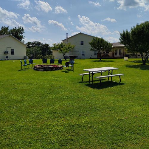 Exterior:  the outdoor bonfire ring and picnic table. Both are shared among all cabins.