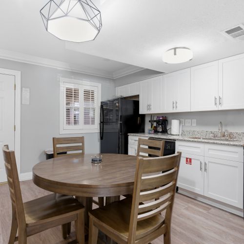 Spacious kitchen w/ ample counter space, cabinetry & a dining nook.