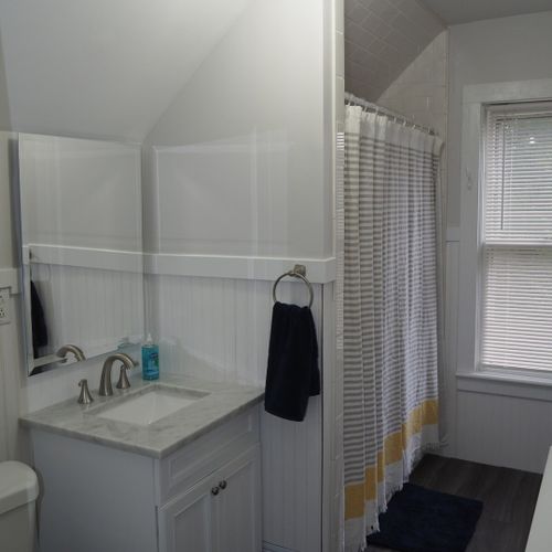 Bathroom #2 (upstairs):  there is a full bathroom upstairs with a combination bathtub / shower, toilet, vanity, sink, and mirror.
