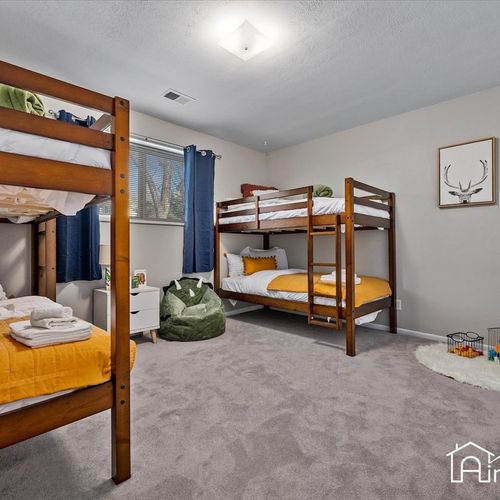 - kid approved bunk room with two twin over twin wood bunk beds and playful decor
- includes a bean bag, toy corner, and blackout curtains for cozy naps or bedtime
- perfect for siblings or groups with a fun and functional layout
